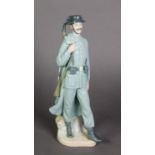 LLADRO, SPANISH PORCELAIN FIGURE OF A SPANISH POLICEMAN, modelled carrying a rifle over his right