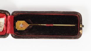 VICTORIAN UNMARKED GOLD COLOURED METAL STICKPIN, the shield shaped top having an old cut diamond