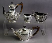 FOUR PIECE EMBOSSED ELECTROPLATED TEA SET, of lobated oval form with brown angular scroll handles