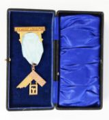 9ct GOLD MASONIC BADGE in the form of a set square and pendant, with presentation inscription from