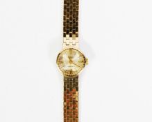 LADY'S ACCURIST 9ct GOLD BRACELET WATCH with 21 jewels movement, small circular silvered dial with