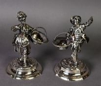 PAIR OF VICTORIAN FILLED SILVER FIGURAL SALTS, modelled as young street vendors, carrying an open