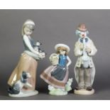 THREE LLADRO FIGURE GROUPS, Saxophone Clown, Crazy Cat Lady, and Girl with Basket of Flowers; 9 5/8"