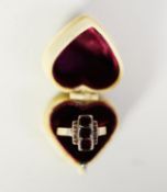 VICTORIAN GOLD COLOURED METAL RING, the top cross set with three garnets, cross set with a row of