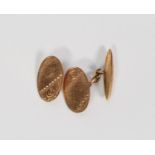 PAIR OF 9ct GOLD CUFFLINKS with foliate engraved oval tops, chain linked to a torpedo shaped back (