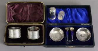 LATE VICTORIAN CASED PAIR OF ENGRAVED SILVER NAPKIN RINGS, each with beaded border and floral