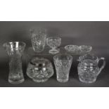 A CUT GLASS BULBOUS ROSE BOWL, with metal grille; three cut glass flower vases; a heavy cut glass