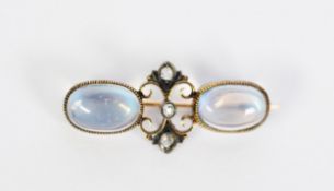EDWARDIAN 15CT GOLD BROOCH, the double C scroll centre set with three tiny rose diamonds flanked