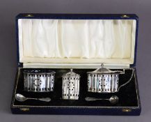 CASED GEORGIAN STYLE PIERCED AND ENGRAVED THREE PIECE SILVER CONDIMENT SET BY S J ROSE, of lobated