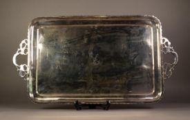 ELECTROPLATED TWO HANDLED OBLONG TEA TRAY, initialled 'L', with cavetto borders and wavy edge, cast