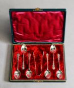 CASED SET OF SIX ELECTROPLATED COFFEE SPOONS AND MATCHING PAIR OF SUGAR TONGS, the spoons with
