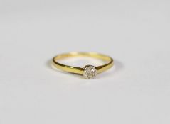 18ct GOLD AND PLATINUM RING collet set with a small solitaire diamond in a deceptive setting, 1.