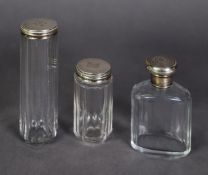 THREE VICTORIAN AND LATER PANEL CUT GLASS TOILET JARS WITH SCREW OFF SILVER COVER, comprising: A