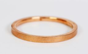 9ct GOLD HOLLOW BANGLE with engine turned flat top, 3 1/4in (8.5cm) overall diameter, Birmingham