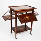 EDWARDIAN MAHOGANY TWO-TIER OBLONG TEA TABLE, with a fall leaf to each of the four sides, 21” x