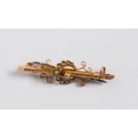 15ct GOLD BAR BROOCH, the centre overlaid with a crescent set with seed peals flanked by scrolls,