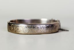 SILVER HINGE-OPENING BANGLE with scroll top, Birmingham 1963, in case