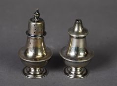 GEORGE V PAIR OF SILVER PEDESTAL SALT AND PEPPER POTS, each of compressed form with pull-off