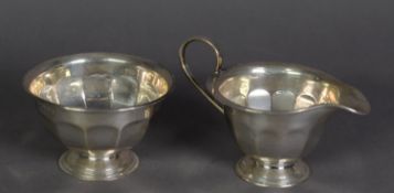 GEORGE V SILVER PEDESTAL MILK JUG AND MATCHING SUGAR BASIN BY EDWARD VINERS, of panelled form, the