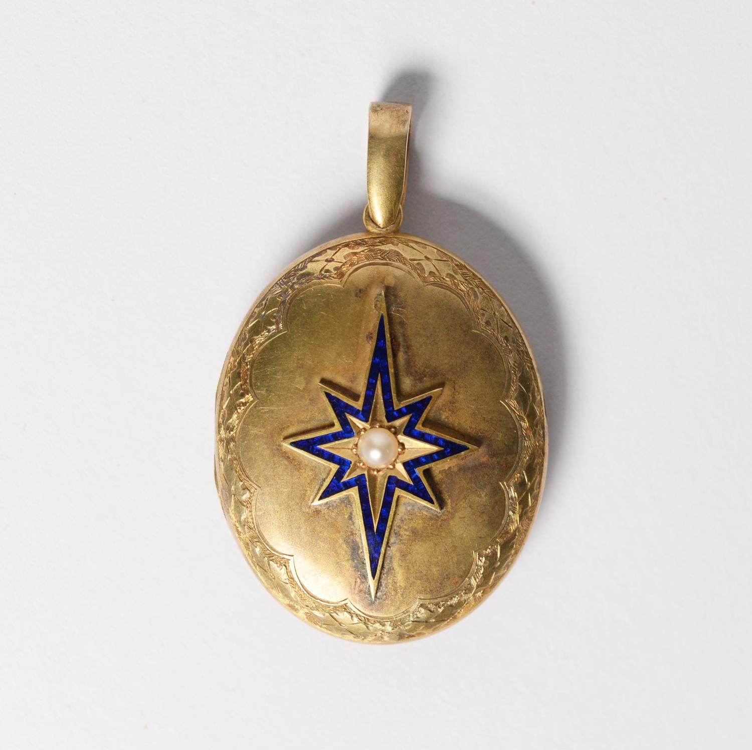 VICTORIAN GOLD COLOURED METAL OVAL LOCKET PENDANT, the font applied with a blue enamelled star burst