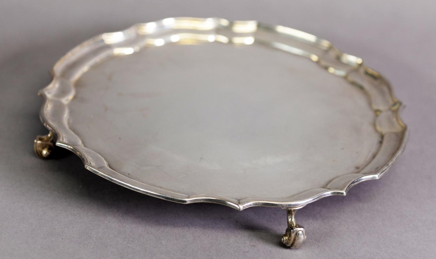 GEORGIAN STYLE SILVER SALVER, with plain centre, moulded border and volute scroll feet, 10” (25.4cm)