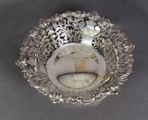 GEORGE V PIERCED SILVER FRUIT DISH, of steep sided form with slightly domed centre and fancy shell