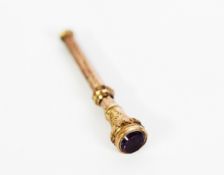 SILVER ENGRAVED AND CHASED RETRACTABLE TOOTHPICK, the top set with an amethyst, 1 3/4in (4.4cm) long