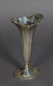 GEORGE V SCOTTISH SILVER TRUMPET VASE, of panelled form with fancy scroll borders, 6 ½” (16.5cm)