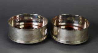 PAIR OF PLAIN SILVER WINE COASTERS BY CARRS, SHEFFIELD, each with moulded borders and turned