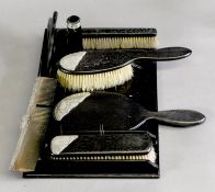 GEORGE V ENGRAVED SILVER MOUNTED EBONY LADY’S DRESSING TABLE SET, initialled, comprising: HAIR