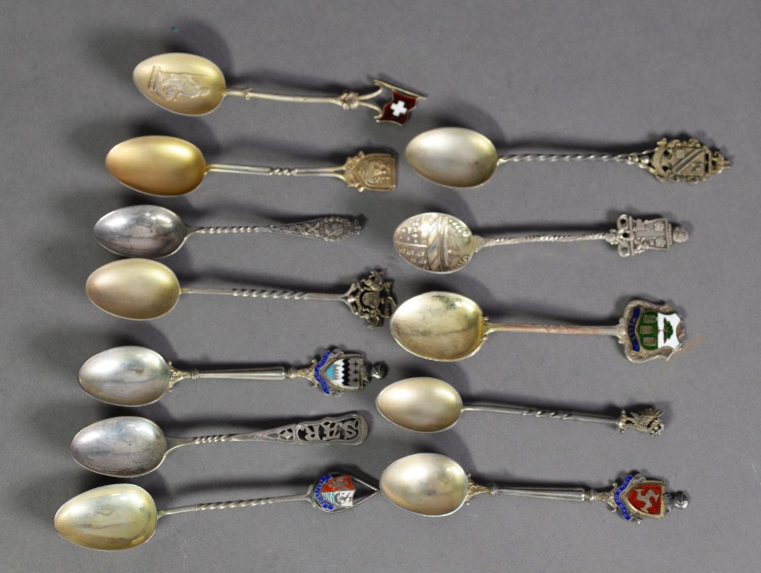 NINE EDWARD VII AND LATER SILVER SOUVENIR TEASPOONS, including THREE WITH ENAMEL TOPS, together with
