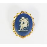 19th CENTURY WEDGWOOD BLUE AND WHITE JASPER WARE OVAL BROOCH depicting the Goddess Diana, seated