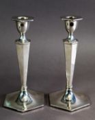 GEORGE V PAIR OF WEIGHTED SILVER CANDLESTICKS BY WALKER & HALL of hexagonal form with tapering