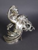 A SILVER CASED RESIN GROUP, male and female semi-draped figures in an open embrace, she with flowing