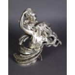 A SILVER CASED RESIN GROUP, male and female semi-draped figures in an open embrace, she with flowing