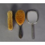 MATCHED THREE PIECE ENGINE TURNED SILVER BACKED DRESSING TABLE HAND MIRROR AND BRUSH SET, the