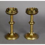 PAIR OF ARTS AND CRAFTS BRASS CANDLESTICKS, each with fancy galleried top above a knopped stem and