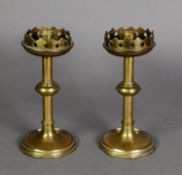 PAIR OF ARTS AND CRAFTS BRASS CANDLESTICKS, each with fancy galleried top above a knopped stem and