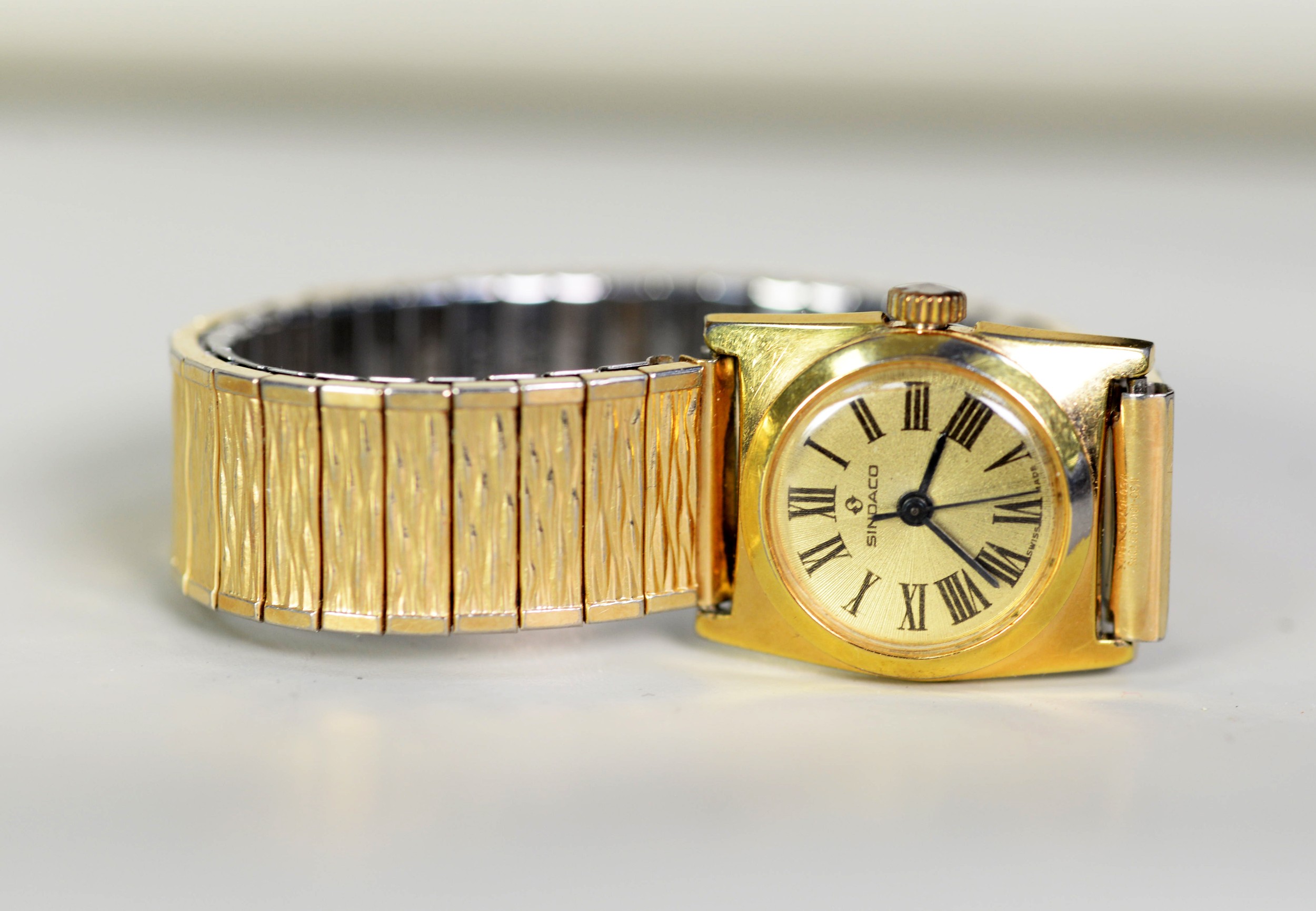LADY'S SINDACO SWISS GOLD PLATED BRACELET WATCH with mechnaical movement, roman dial with centre