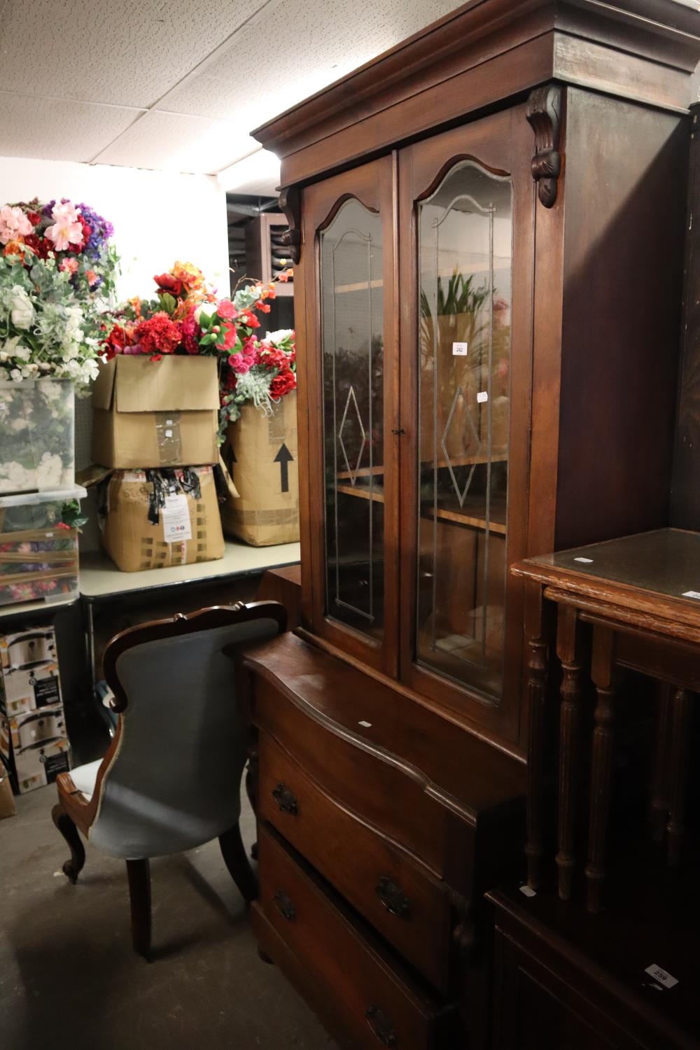 A CONTINENTAL MAHOGANY ELEVATED BOOKCASE, TWO GLAZED DOORS ABOVE THREE DRAWER BASE