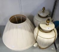 A PAIR OF LARGE CREAM OVULAR, VERTICALLY RIBBED, POTTERY TABLE LAMPS AND THE PLEATED WHITE FABRIC
