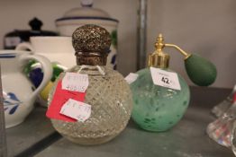 A STUD CUT GLASS GLOBULAR PERFUME BOTTLE WITH PULL-OVER SILVER LID AND A GREEN GLASS PERFUME