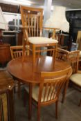 A MCINTOSH TEAK EXTENDING CIRCULAR DINING TABLE AND FIVE TEAK CHAIRS (4 + 1)