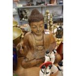 A LARGE CARVED WOODEN FIGURE OF BUDDHA DEPICTED SEATED IN TRADITIONAL LOTUS POSE, 20 ½” HIGH
