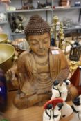 A LARGE CARVED WOODEN FIGURE OF BUDDHA DEPICTED SEATED IN TRADITIONAL LOTUS POSE, 20 ½” HIGH