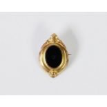 VICTORIAN GOLD PLATED OVAL MOURNING BROOCH set with black onyx (centre stone missing)