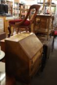 A VICTORIAN MAHOGANY CABRIOLE LEG ROCKING CHAIR, A FADED MAHOGANY BUREAU (A.F.), AND A CARVED WOODEN