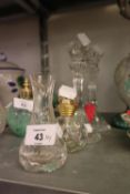 A PAIR OF GLASS CANDLESTICKS, WAISTED AND FLUTED, A CUT GLASS PERFUME BOTTLE AND STOPPER AND A SMALL