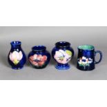 THREE WALTER MOORCROFT TUBE LINED SMALL POTTERY VASES, of varying shapes, comprising: TWO IN THE