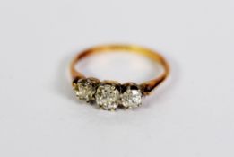 18ct GOLD AND PLATINUM RING set with three old cut round diamonds, the centre stone approximately .